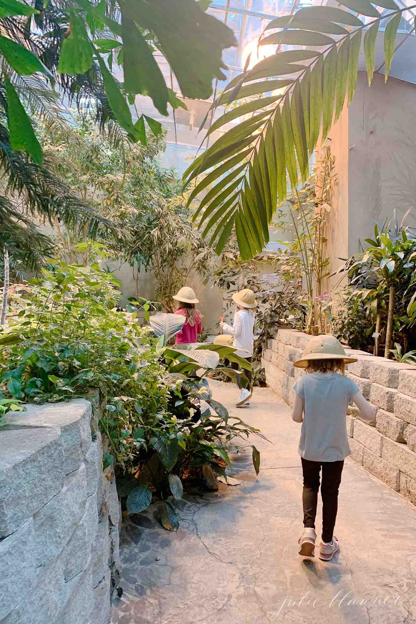 Three little girls walking through butterfly palace, a branson attraction