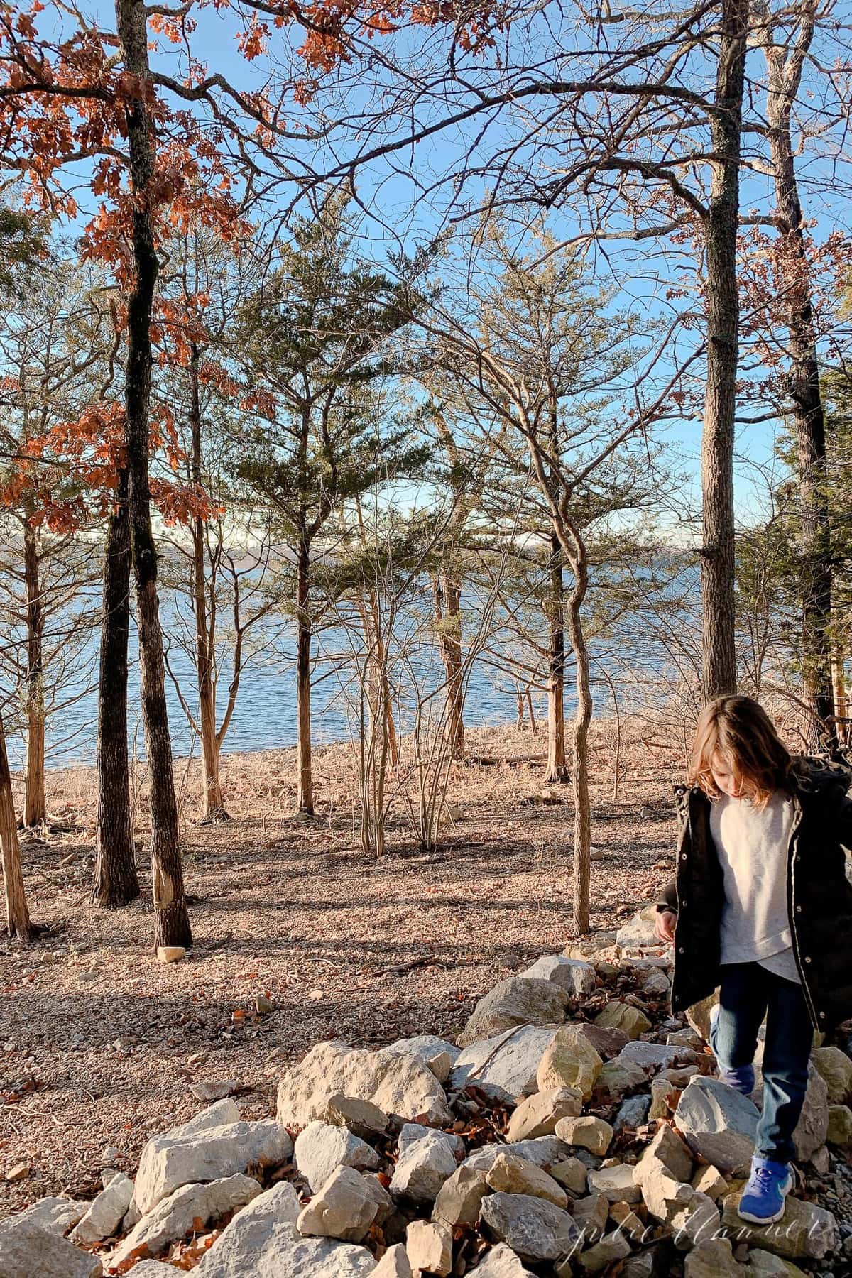 A little girl hiking near water as part of a list of branson mo things to do