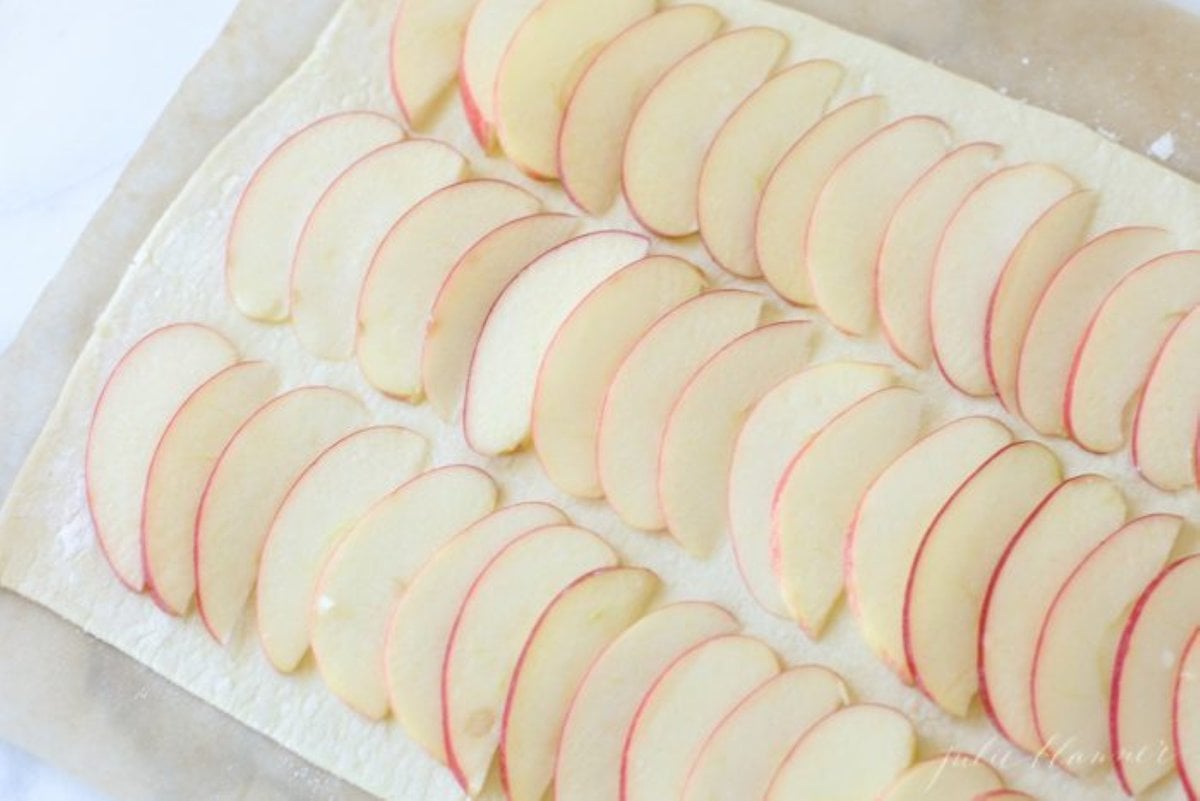 Sliced apples in rows for a caramel apple tart, before it goes into the oven