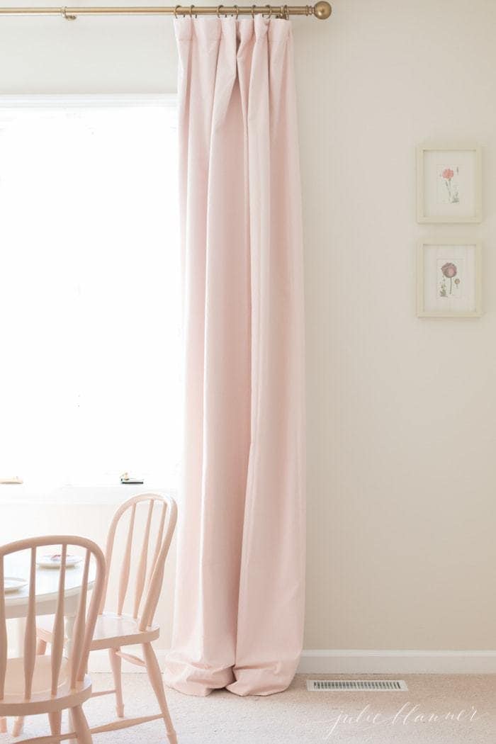 Soft pink velvet curtains in a white kids bedroom.