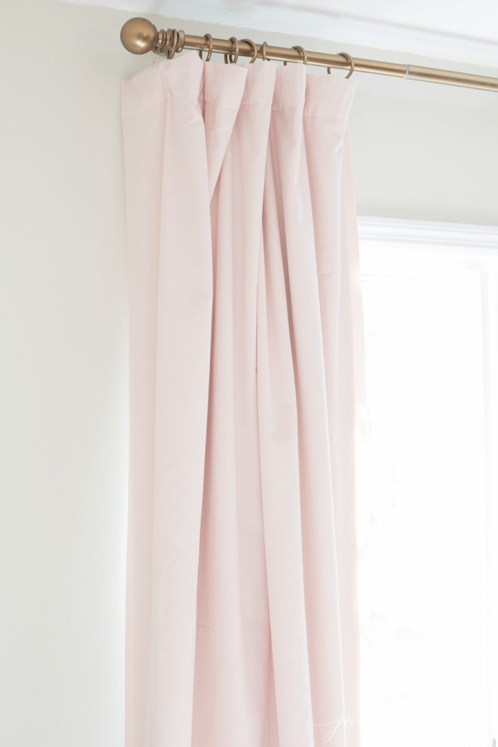 pale pink velvet blackout curtains against white walls.