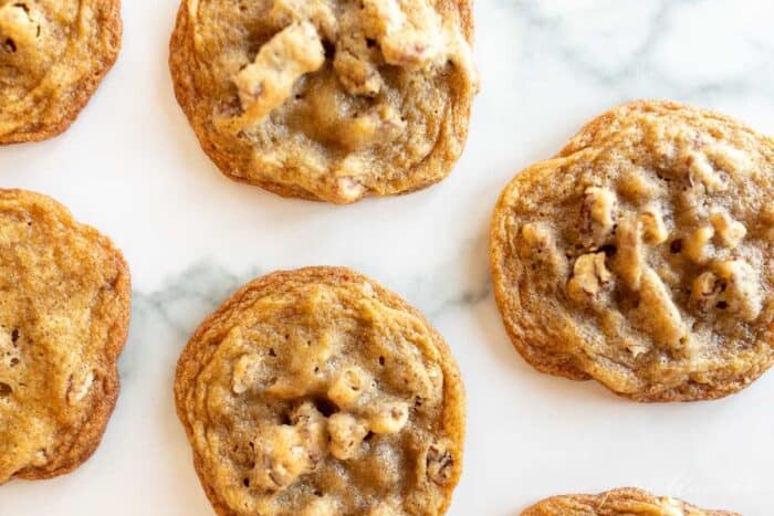 Pecan cookies on a marble surface.