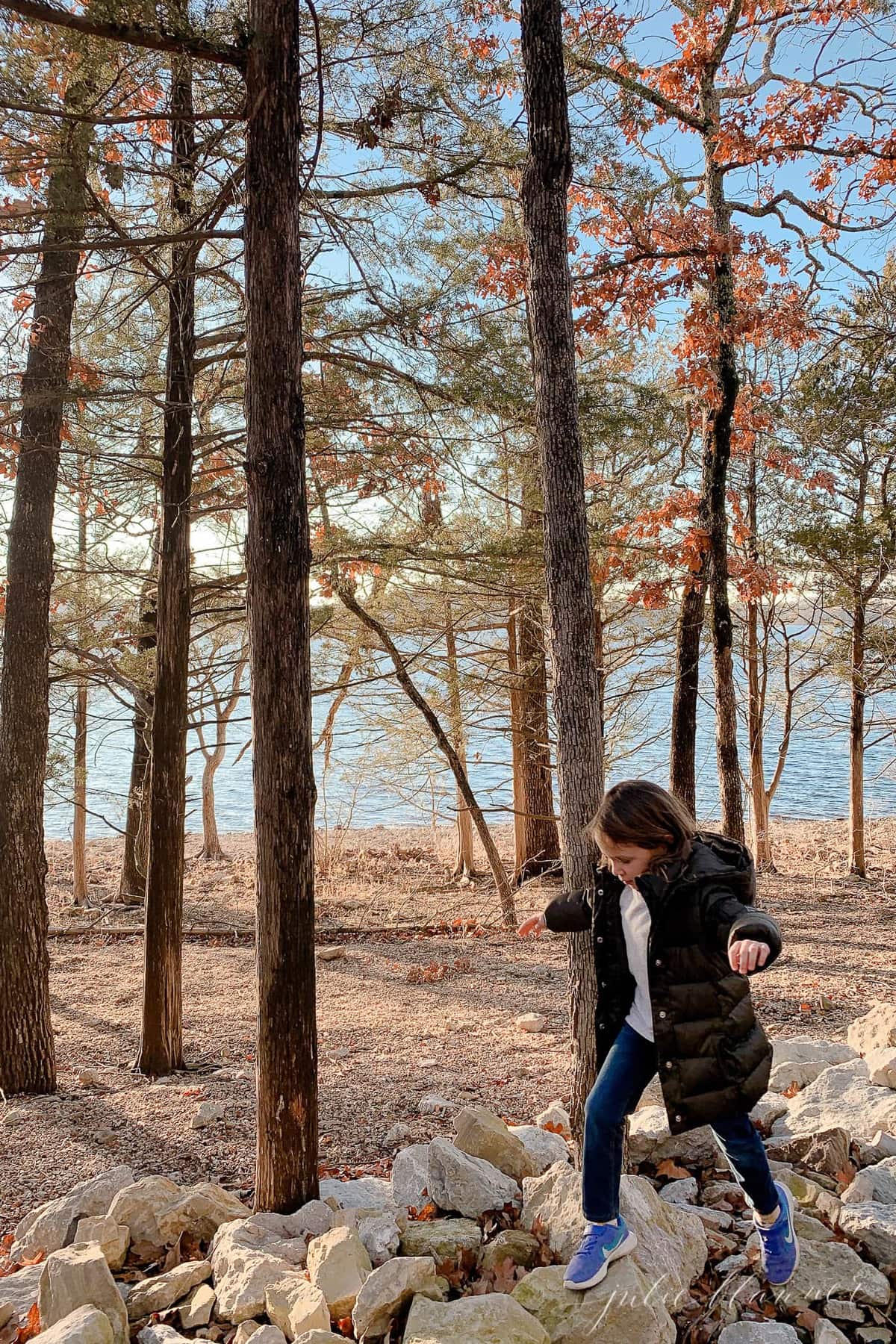 A little girl hiking in the woods on a list of free things to do in branson mo