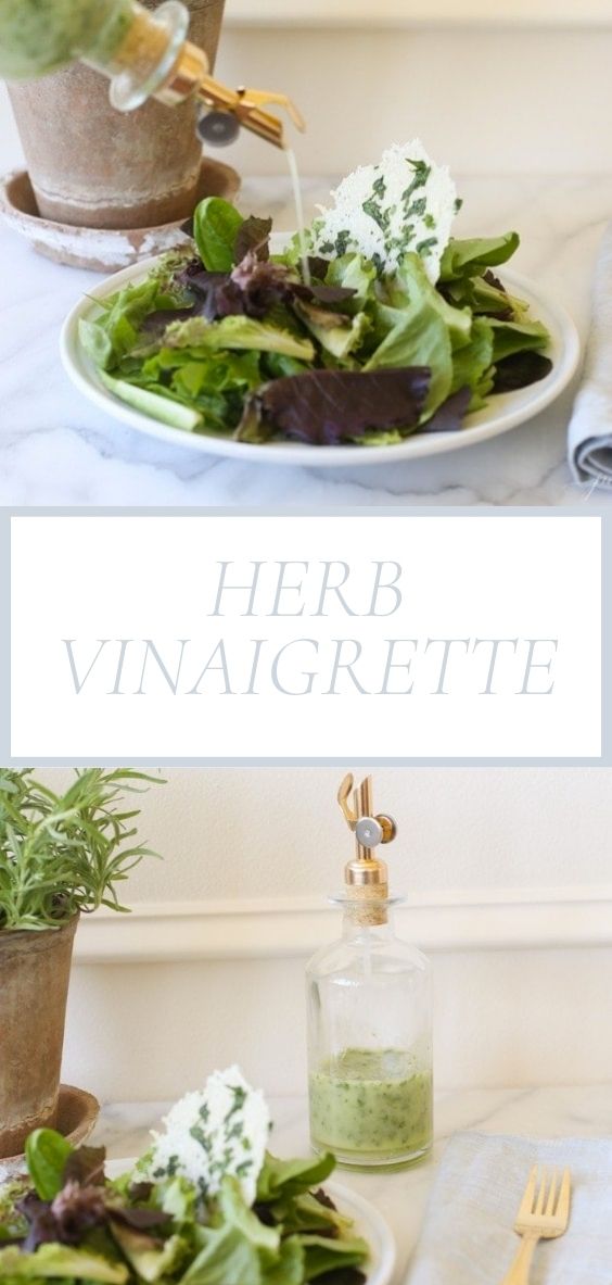 On a marble counter top there is a spring mix salad next to a grey napkin, golden utensils, and a glass bottle of Herb Vinaigrette.