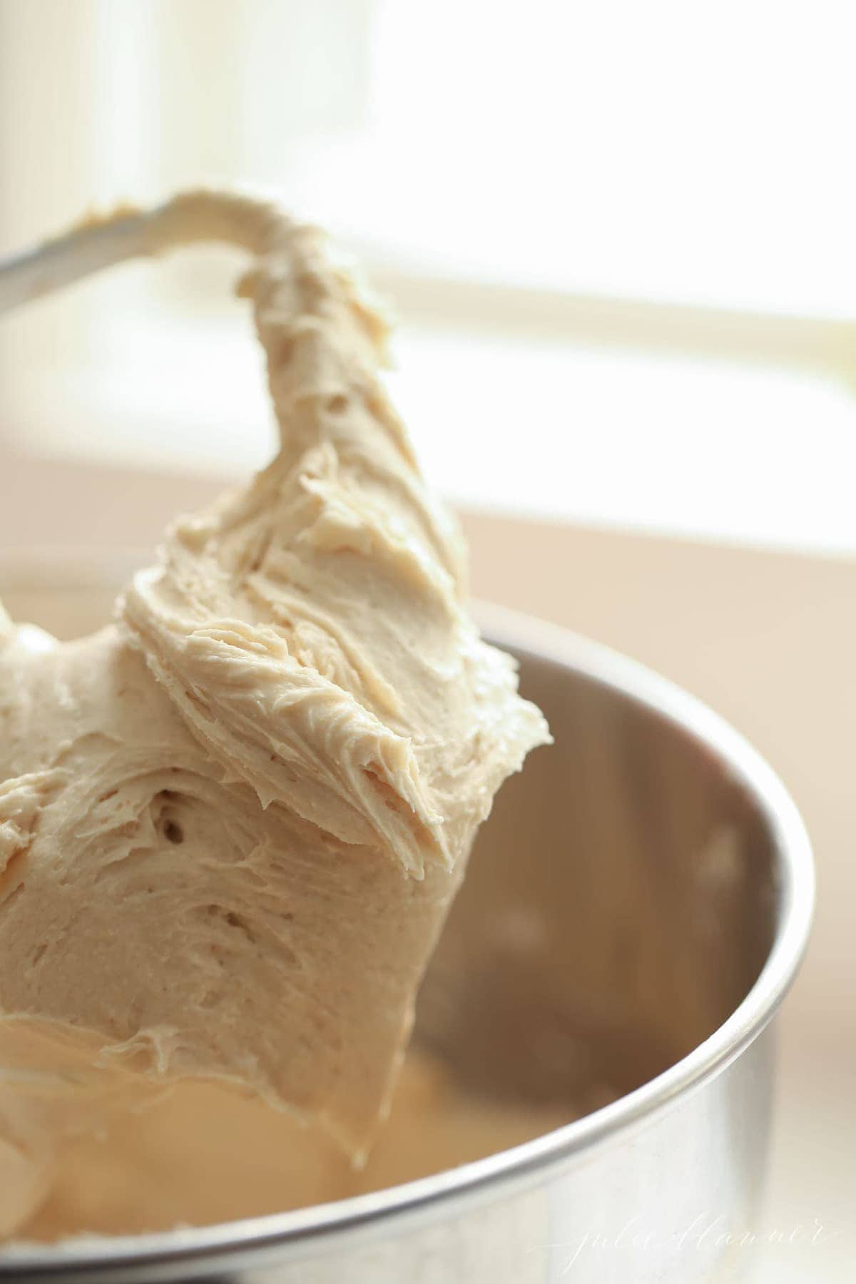 Apple buttercream frosting in a stand mixing bowl. 