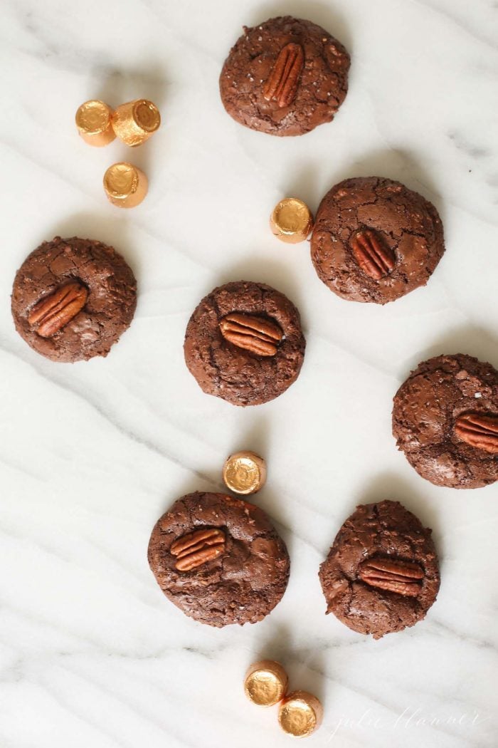 Chocolate turtle cookies on a marble work surface