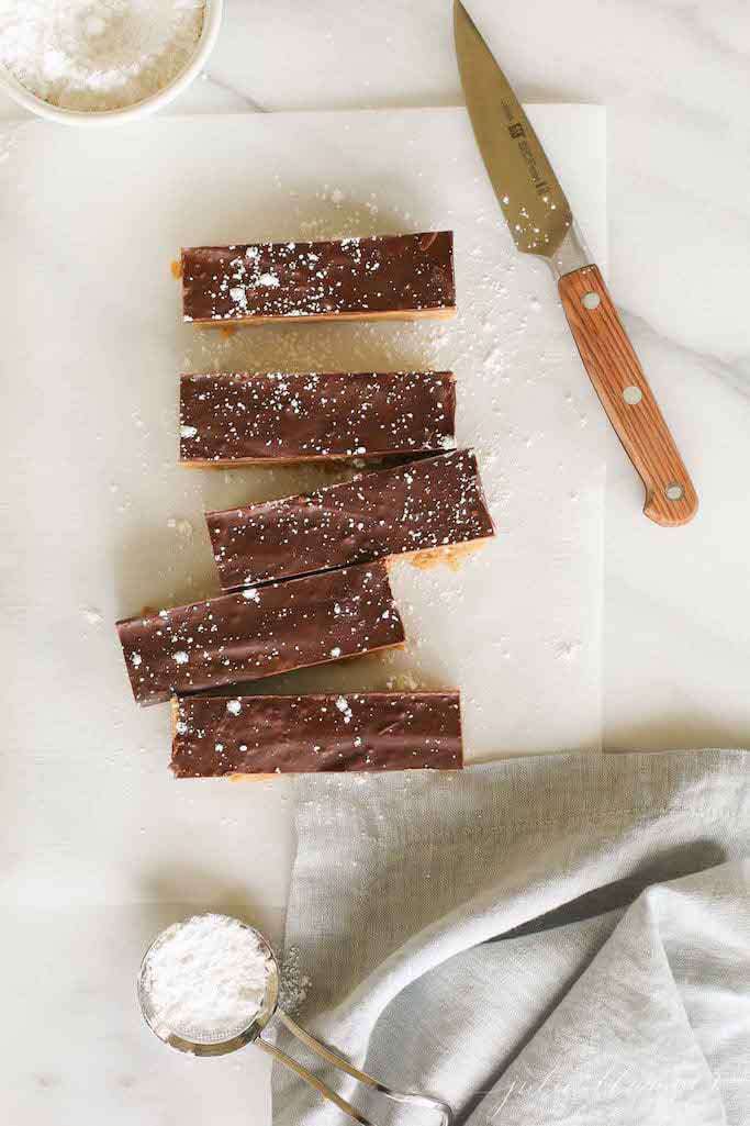 speculoos cookie butter bars on parchment paper with a knife