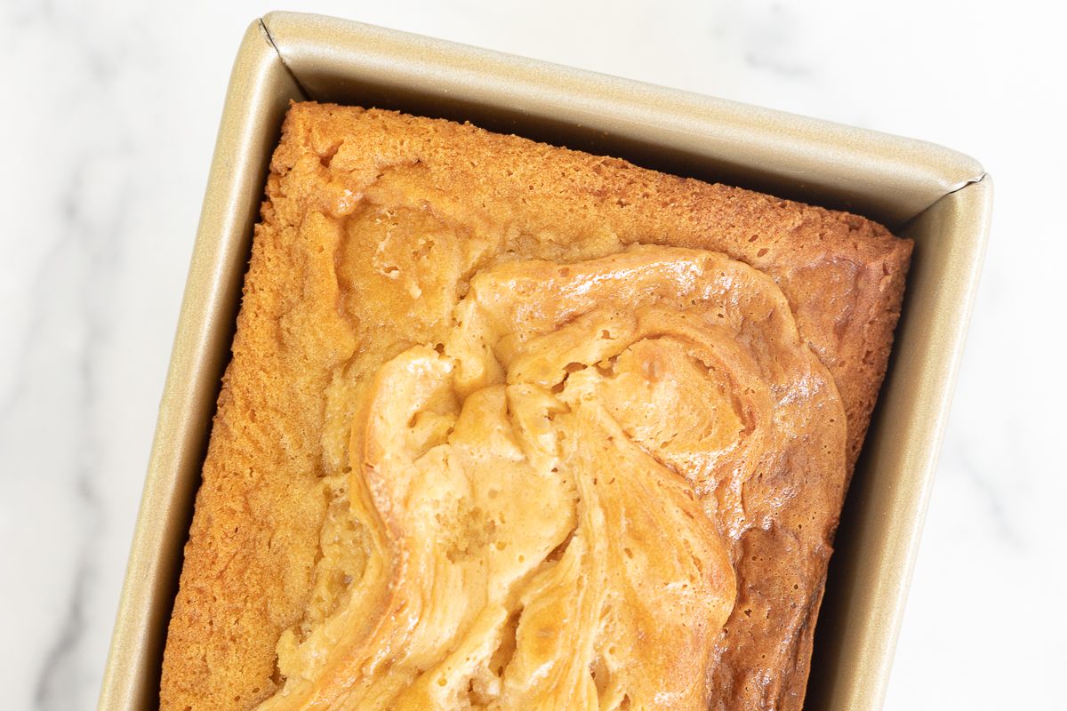 Caramel cream cheese bread baked in a gold loaf pan