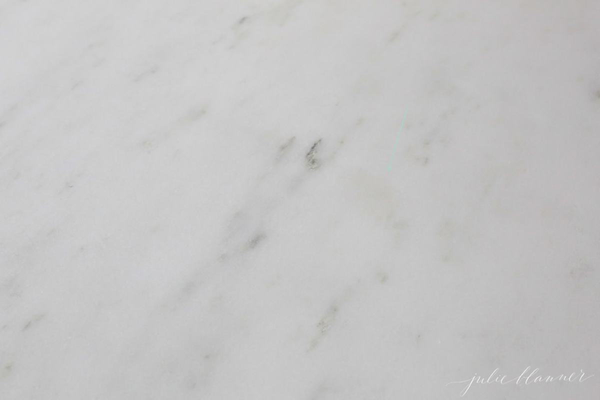 A close up of a marble countertop with an oil stain, after being sealed with DuPont StoneTech BulletProof Sealer.