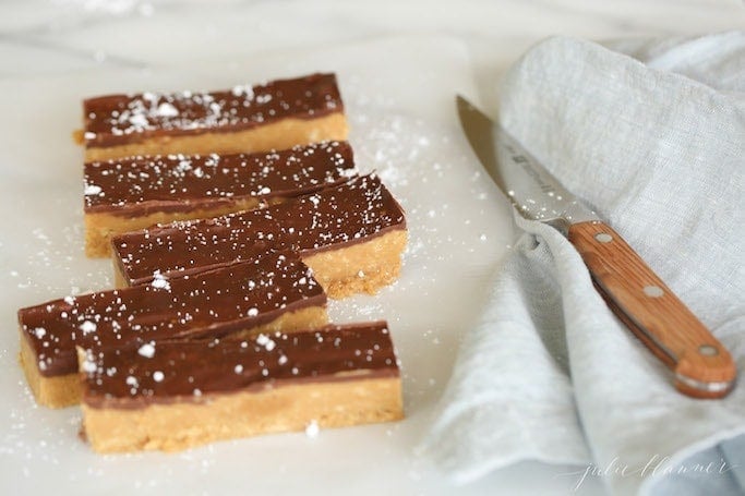 speculoos cookie butter bars on parchment paper with a knife