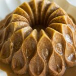 A brown sugar cake in a bundt form, drizzled with caramel sauce