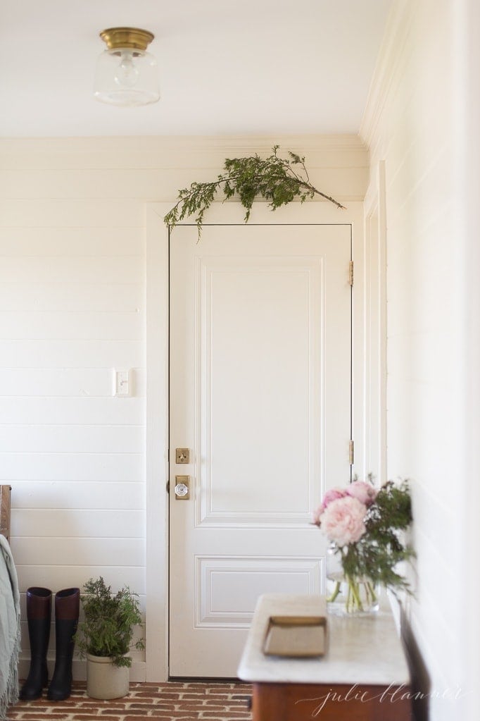 Decorating doors inside the house for Christmas with a simple branch 