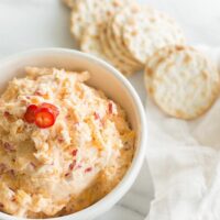 pimento cheese dip in a white bowl with crackers