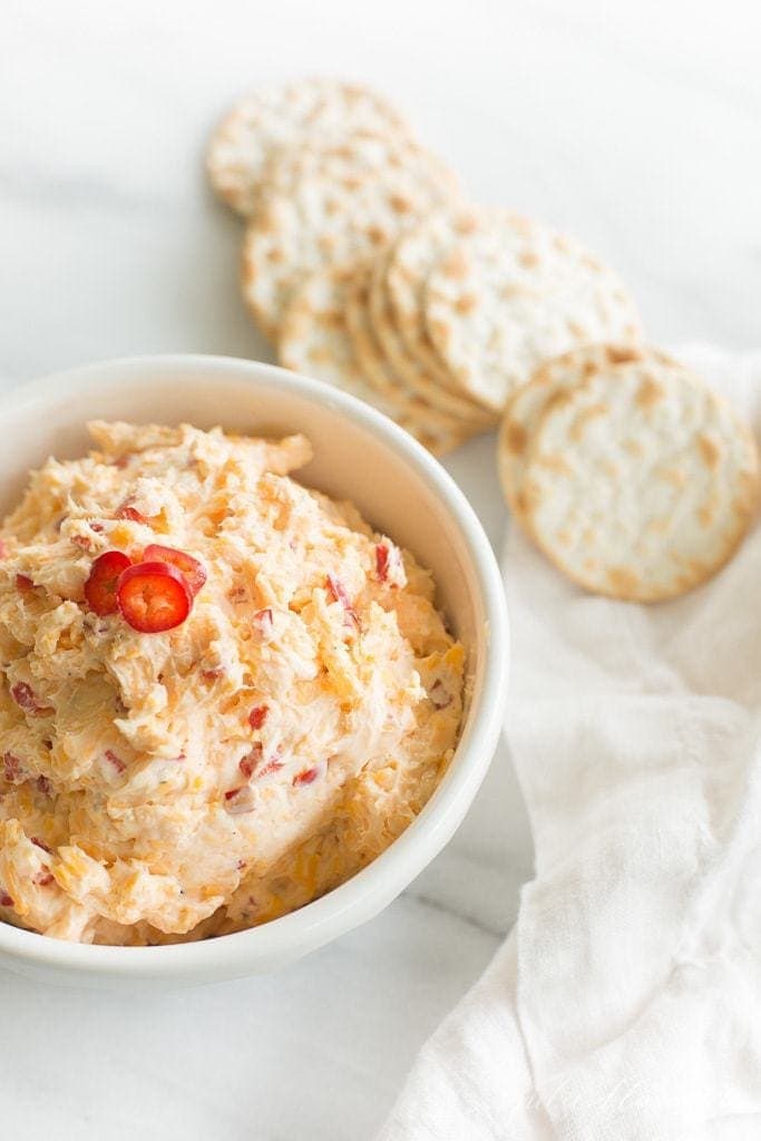 pimento cheese dip in a white bowl with crackers