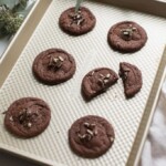 chewy chocolate mint cookies with andes candy on baking sheet