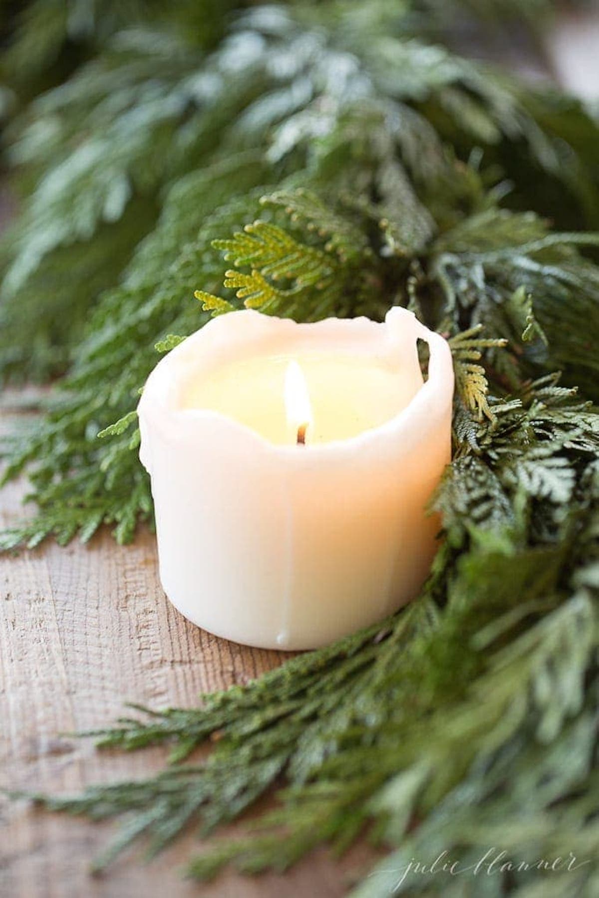 A garland centerpiece with a candle.