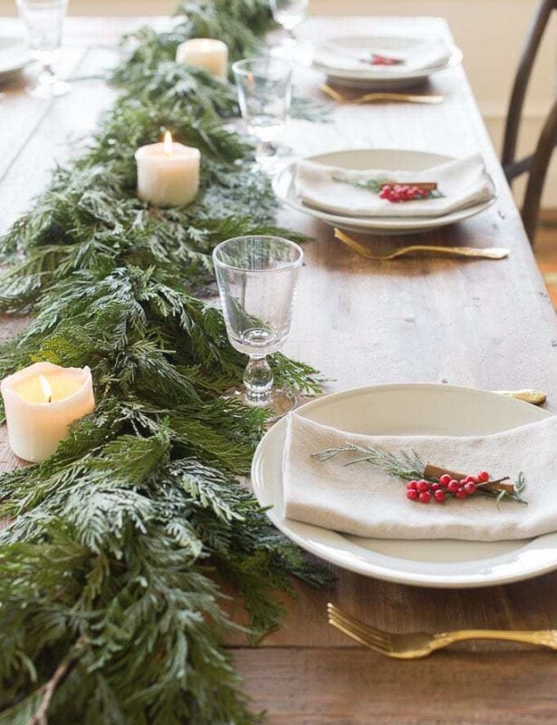 A cedar garland used as a centerpiece down a holiday table