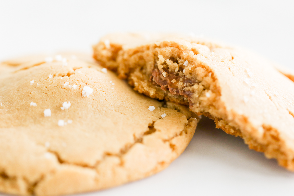 A stuffed peanut butter cookie with a bite taken out of it.