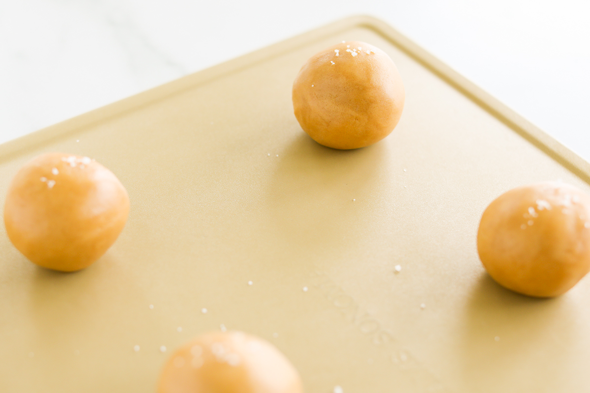 A baking sheet with a bunch of doughnuts on it, including stuffed peanut butter cookies.