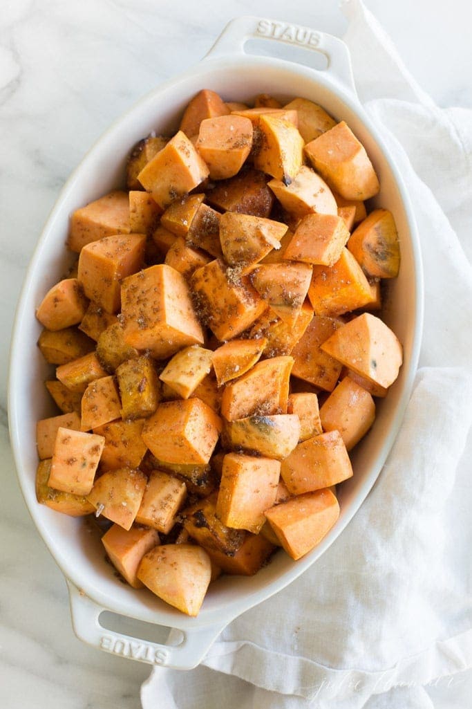 roasted sweet potatoes in a white oval baking dish