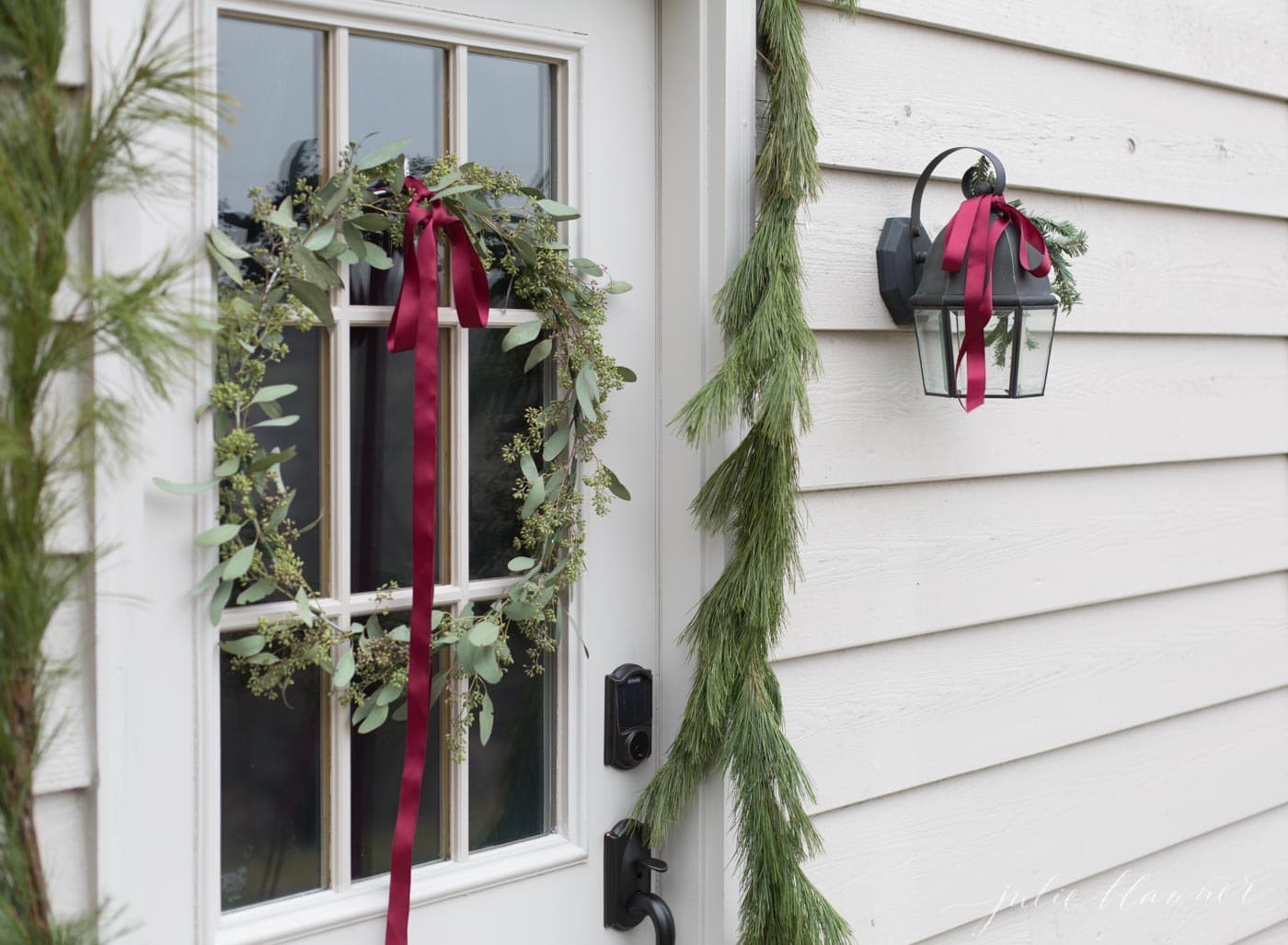 christmas door decorations of Christmas greens and red ribbon