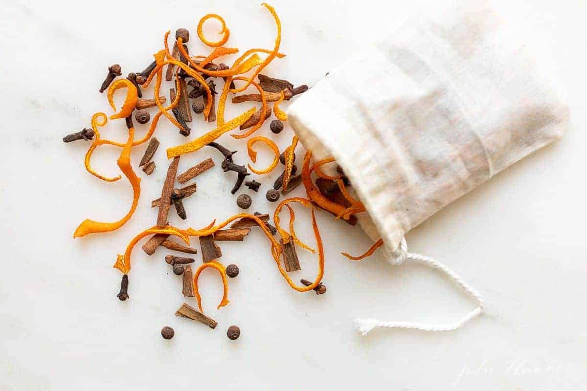 A mulling spices recipe spilling from a white muslin bag.