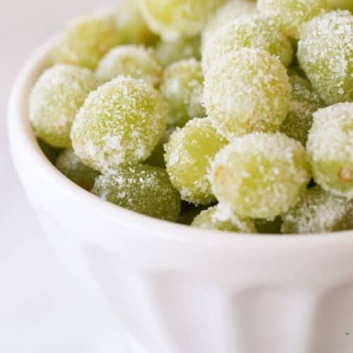 A white bowl full of sugared grapes, a new year's eve recipe