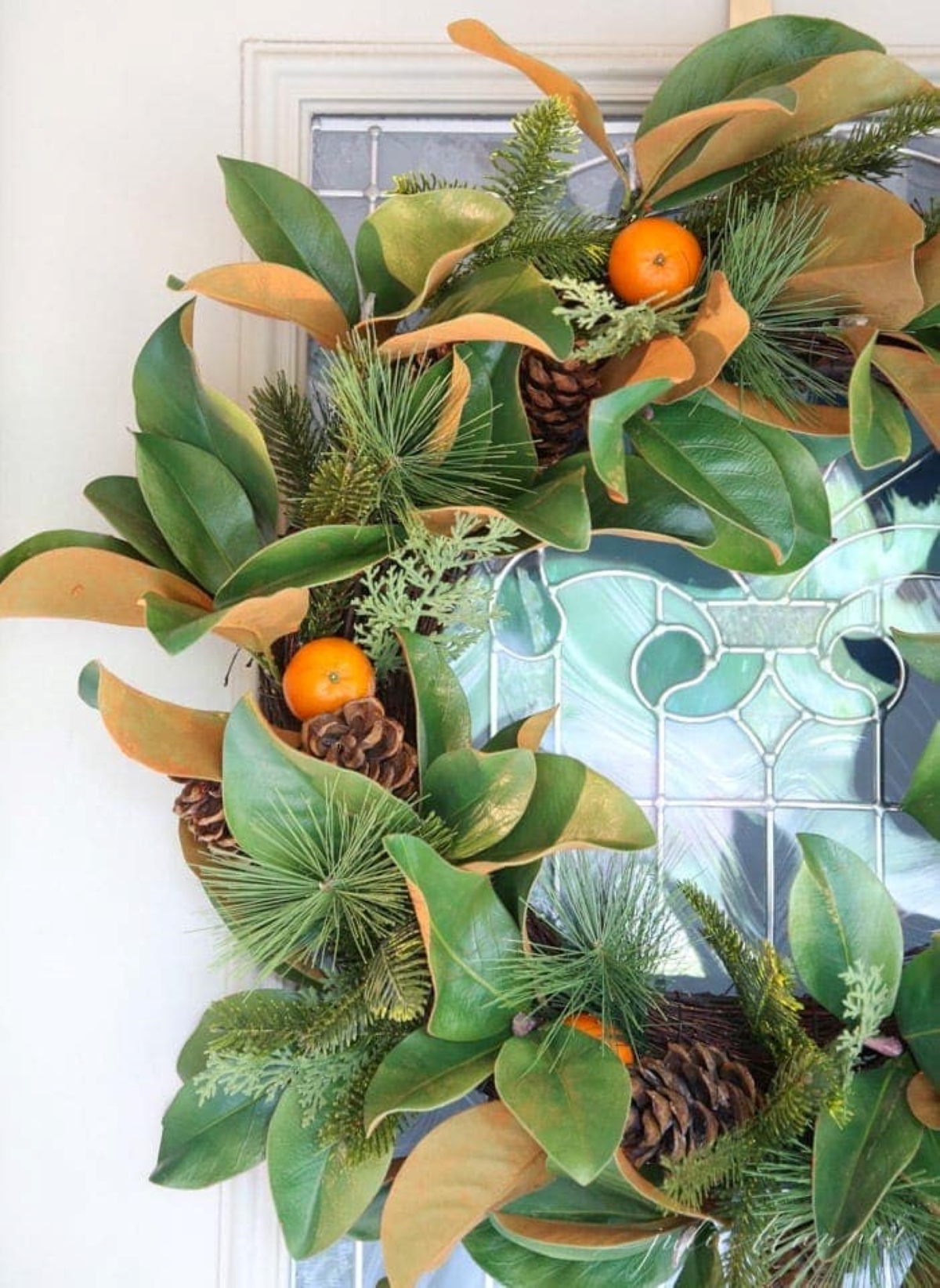 A faux Christmas wreath with clementine oranges