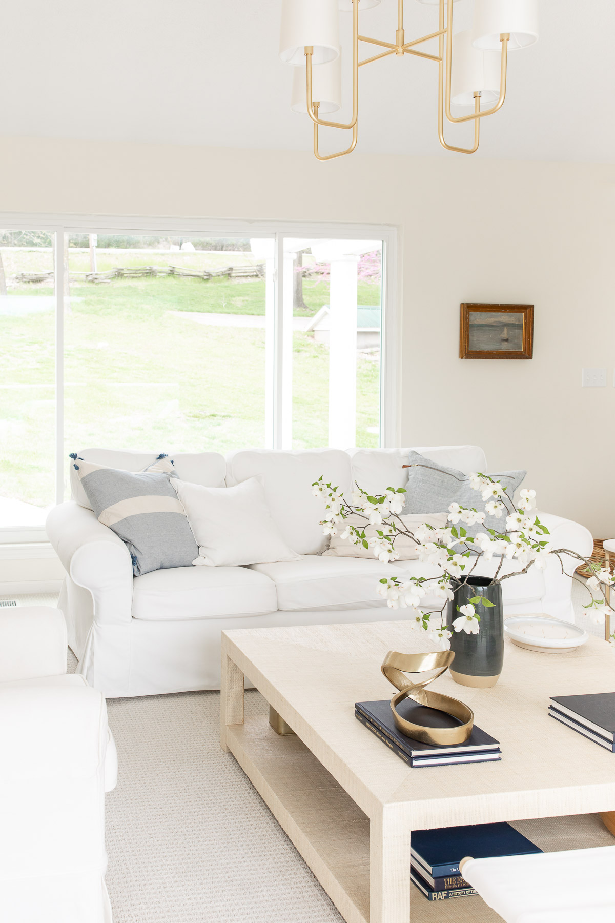 A white couch in a living room, with Farrow and Ball White Tie paint color on the walls. 