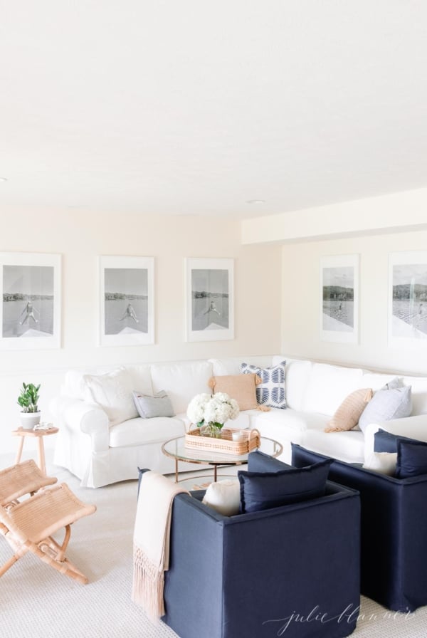 A white couch in a living room, with Farrow and Ball White Tie paint color on the walls.
