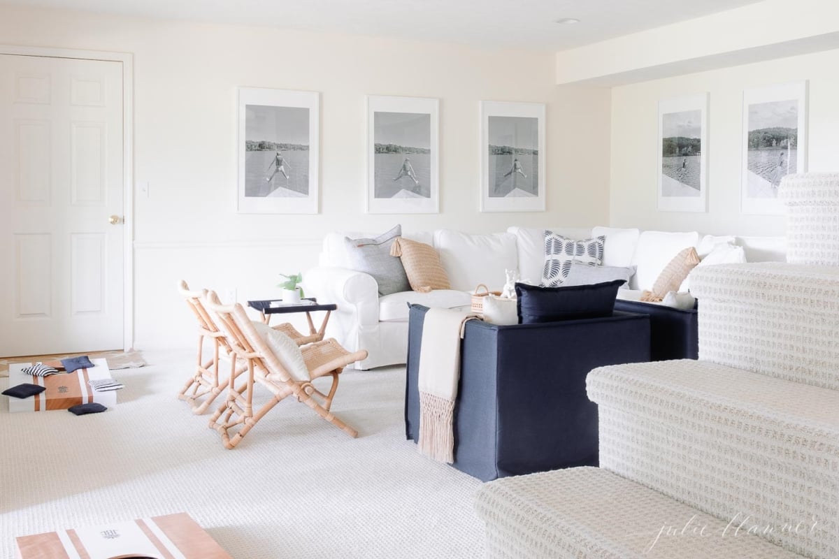 A white living room with a couch and chairs.