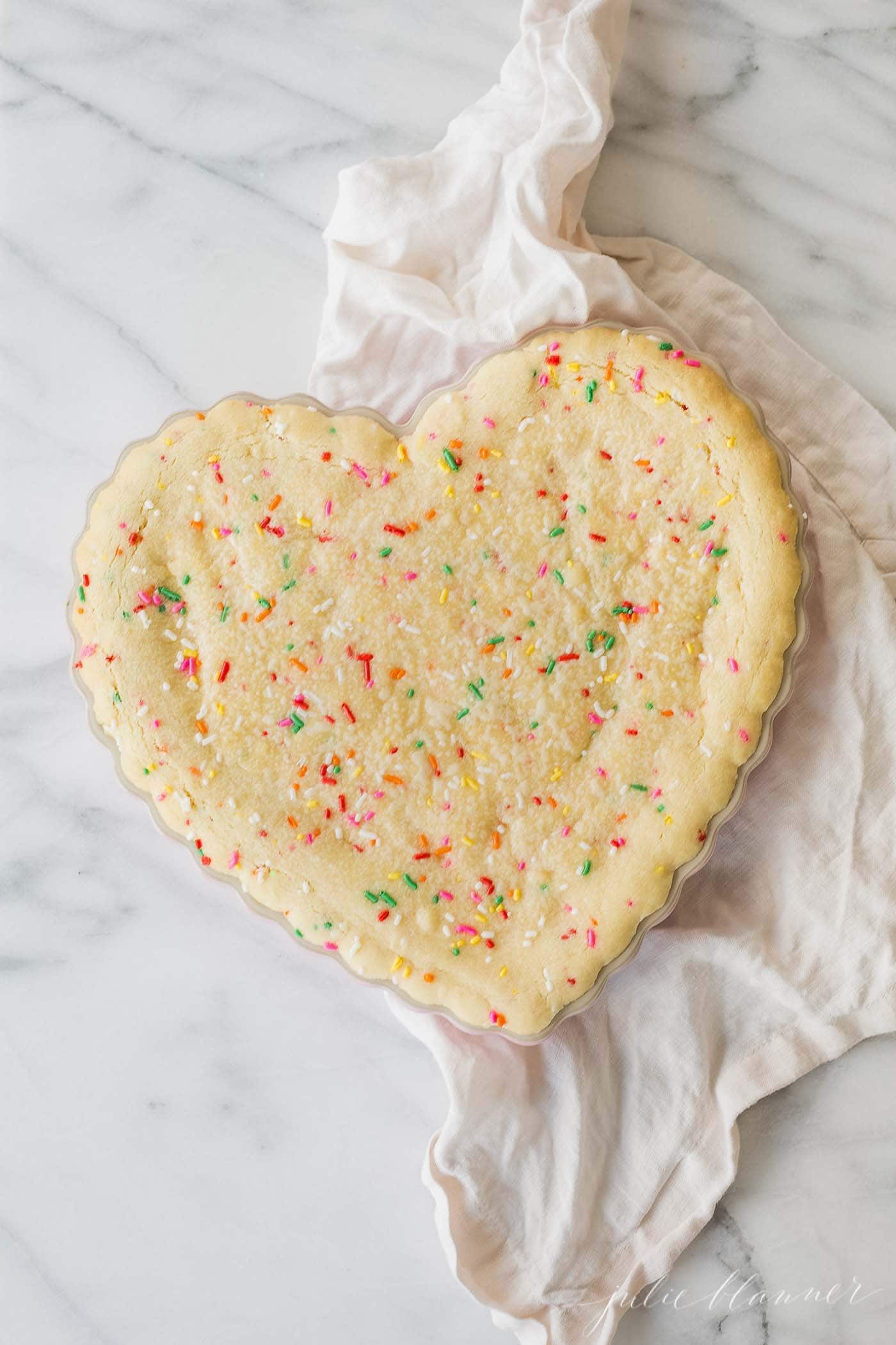 A funfetti cookie cake in a heart pan for a Valentine's Day recipe