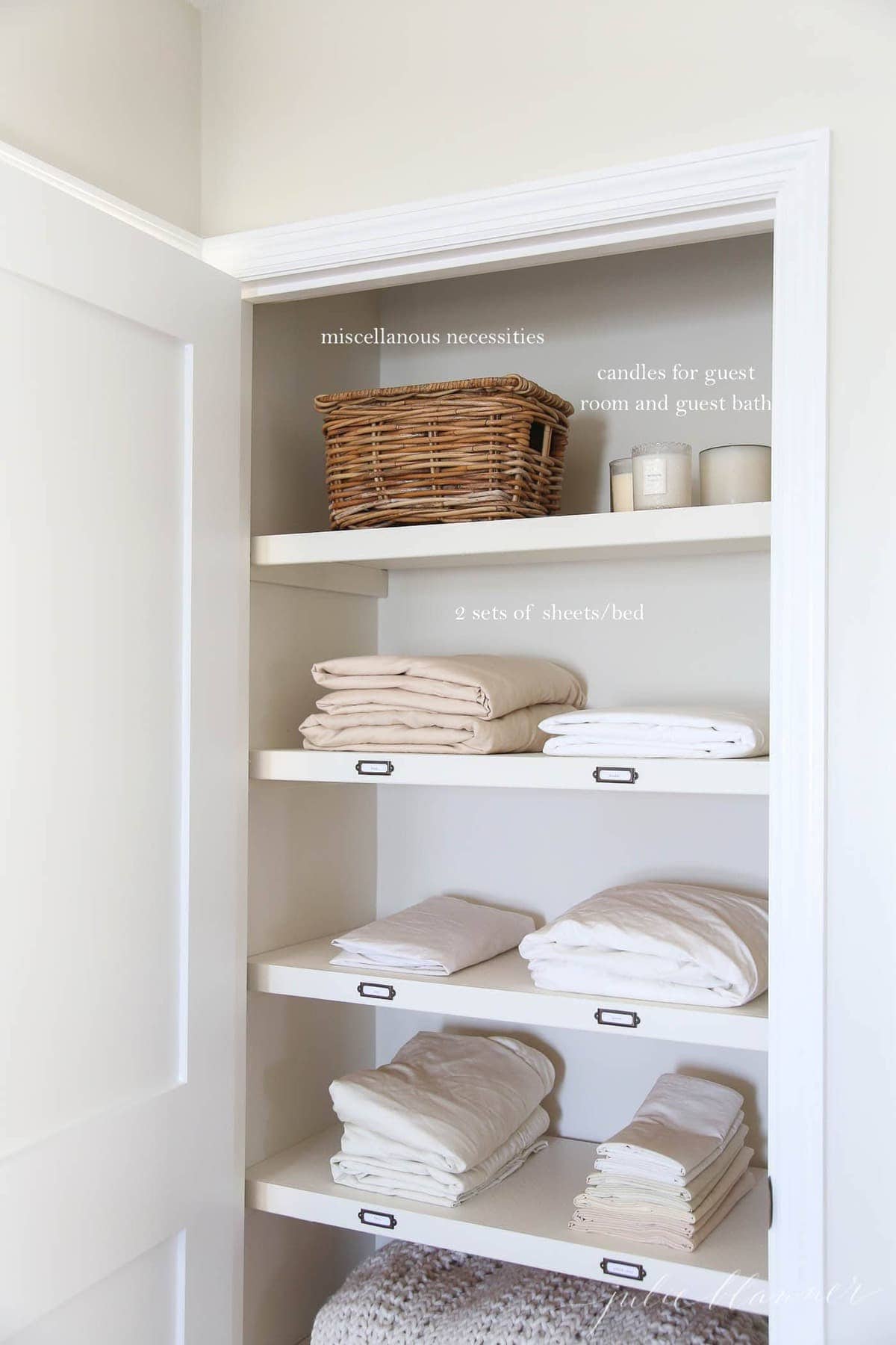 A linen closet stacked with sheets, baskets, etc, with white text overlay describing the items individually