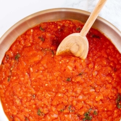 A silver saucepan full of pomodoro sauce