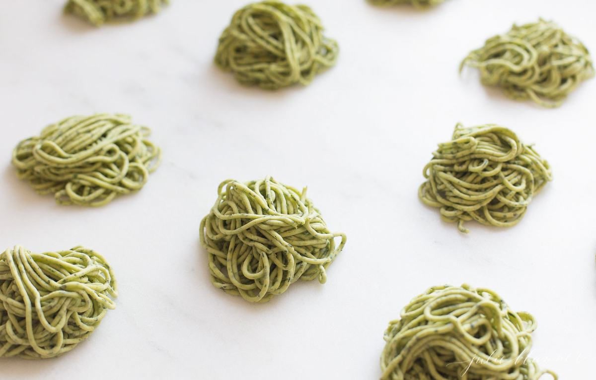 Piles of arugula pasta on a work surface
