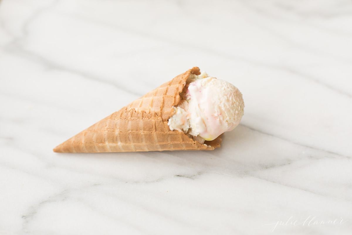 bubble gum ice cream cone on a marble countertop. 