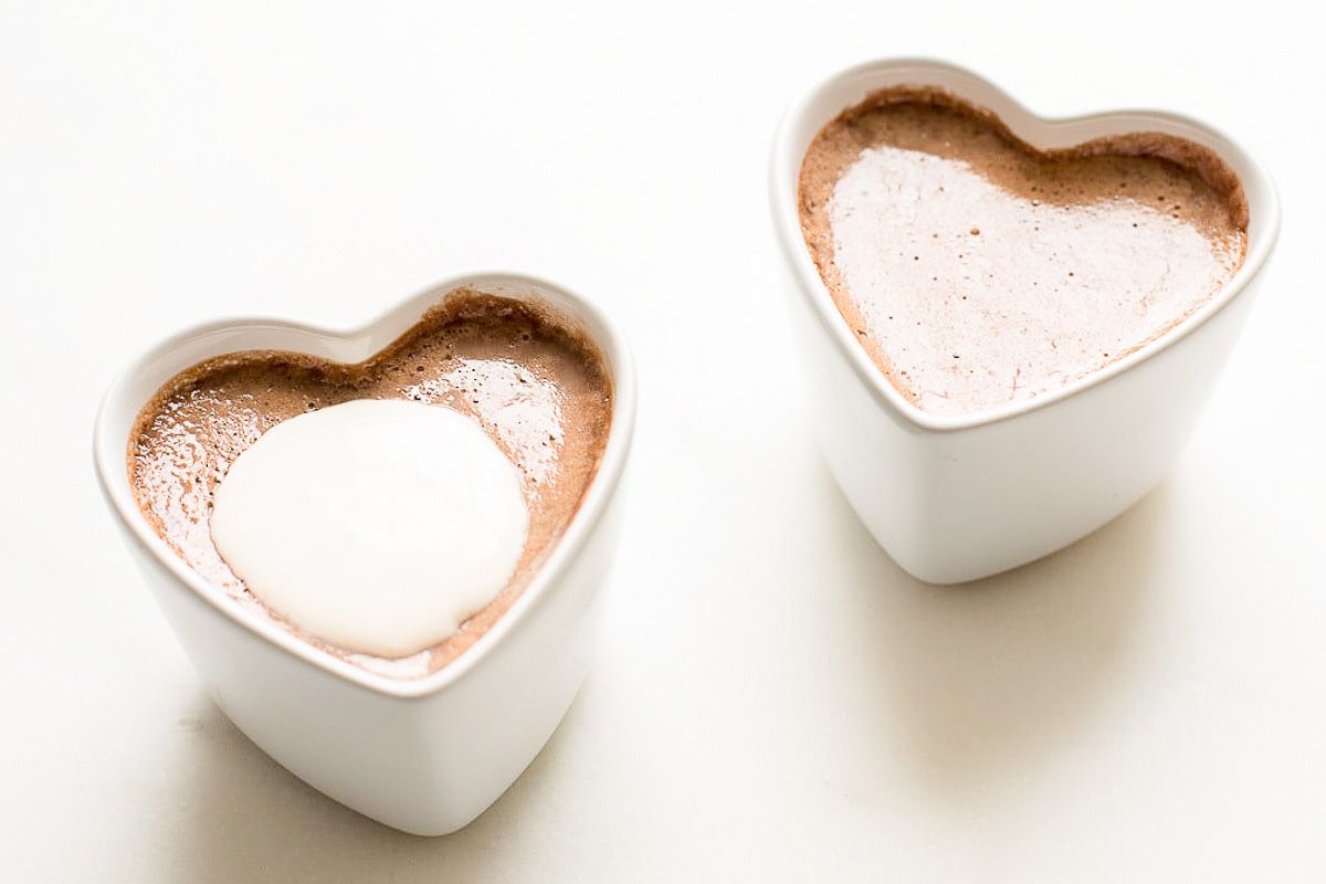 two small heart shaped ceramic containers of chocolate pots de creme