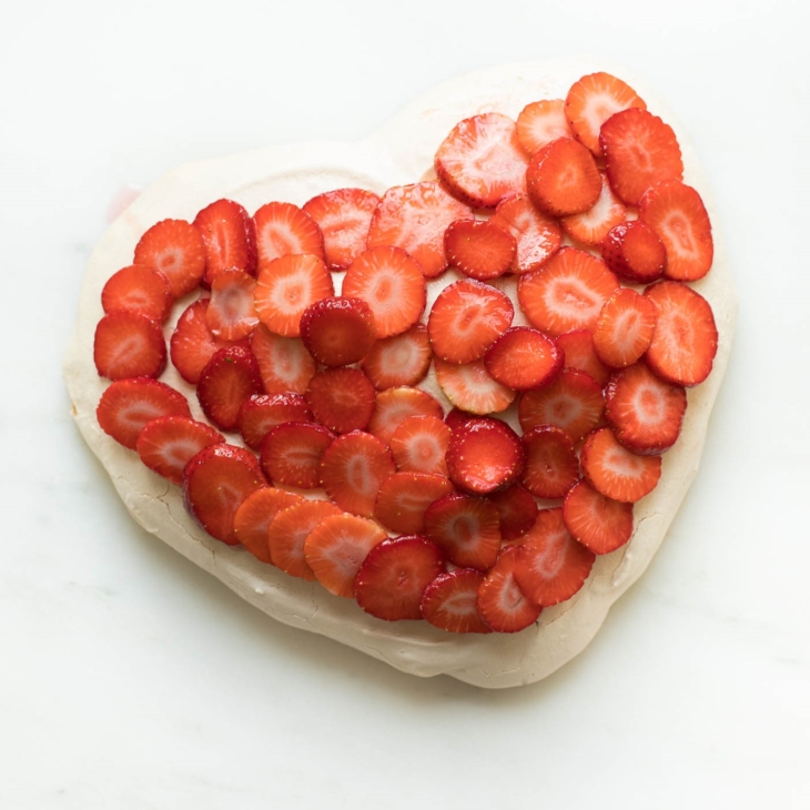 An easy meringue recipe served as a meringue cookie cake, topped with strawberries