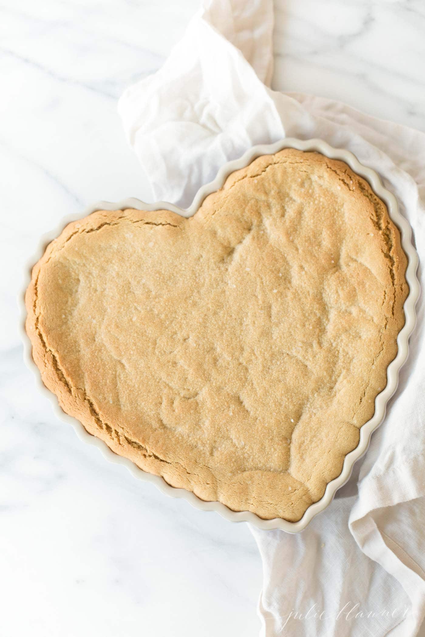 peanut butter cookie cake in heart shaped dish