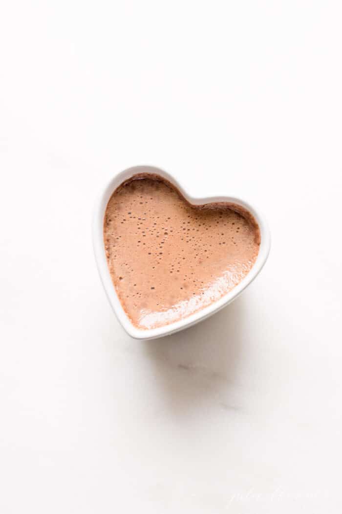 chocolate pots de crème in white ramekin on marble surface