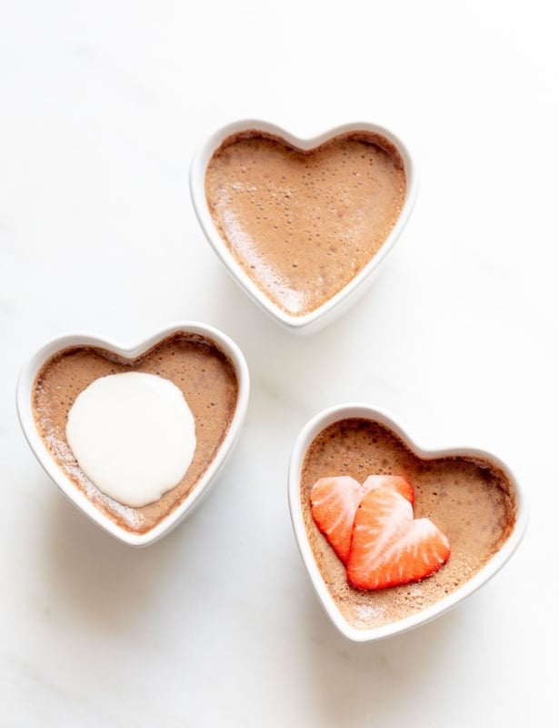 Three small heart shaped ceramic containers of chocolate pots de creme