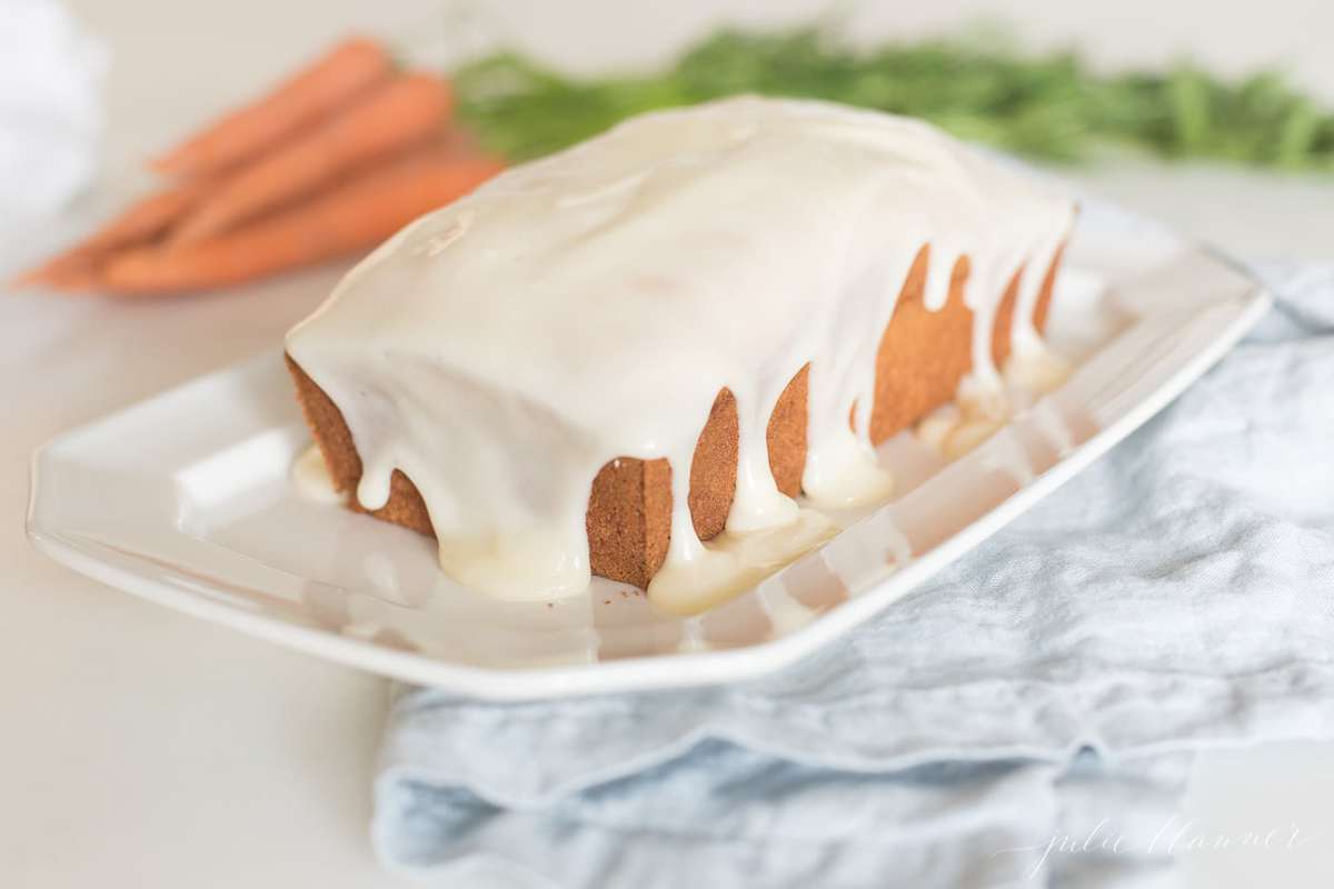 carrot bread on a white plate, fresh carrots in the background