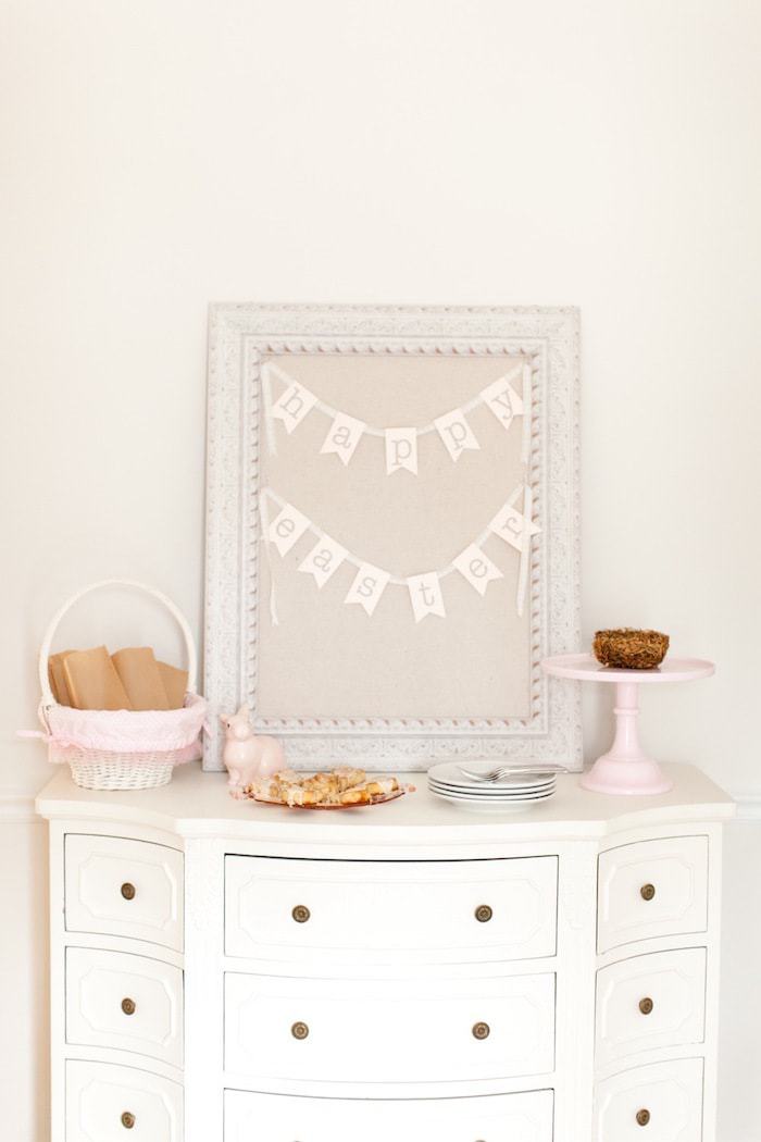 A brunch bar set up on a white dresser, happy easter banner for simple easter decorating touch.