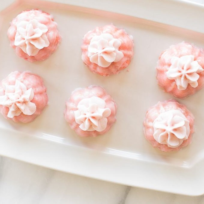 pink champagne cupcakes on a white platter