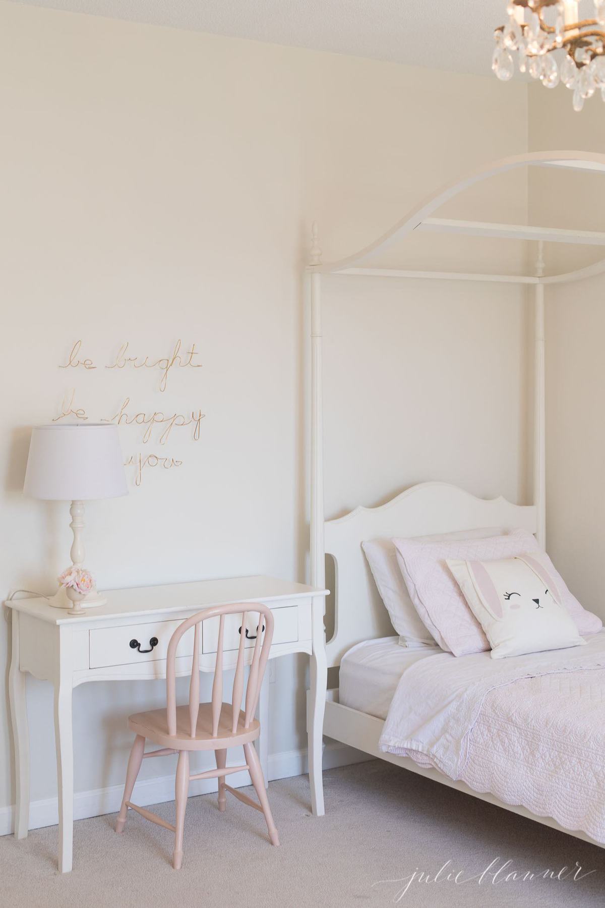 A girl's bedroom with desk and bed painted in Sherwin Williams Creamy