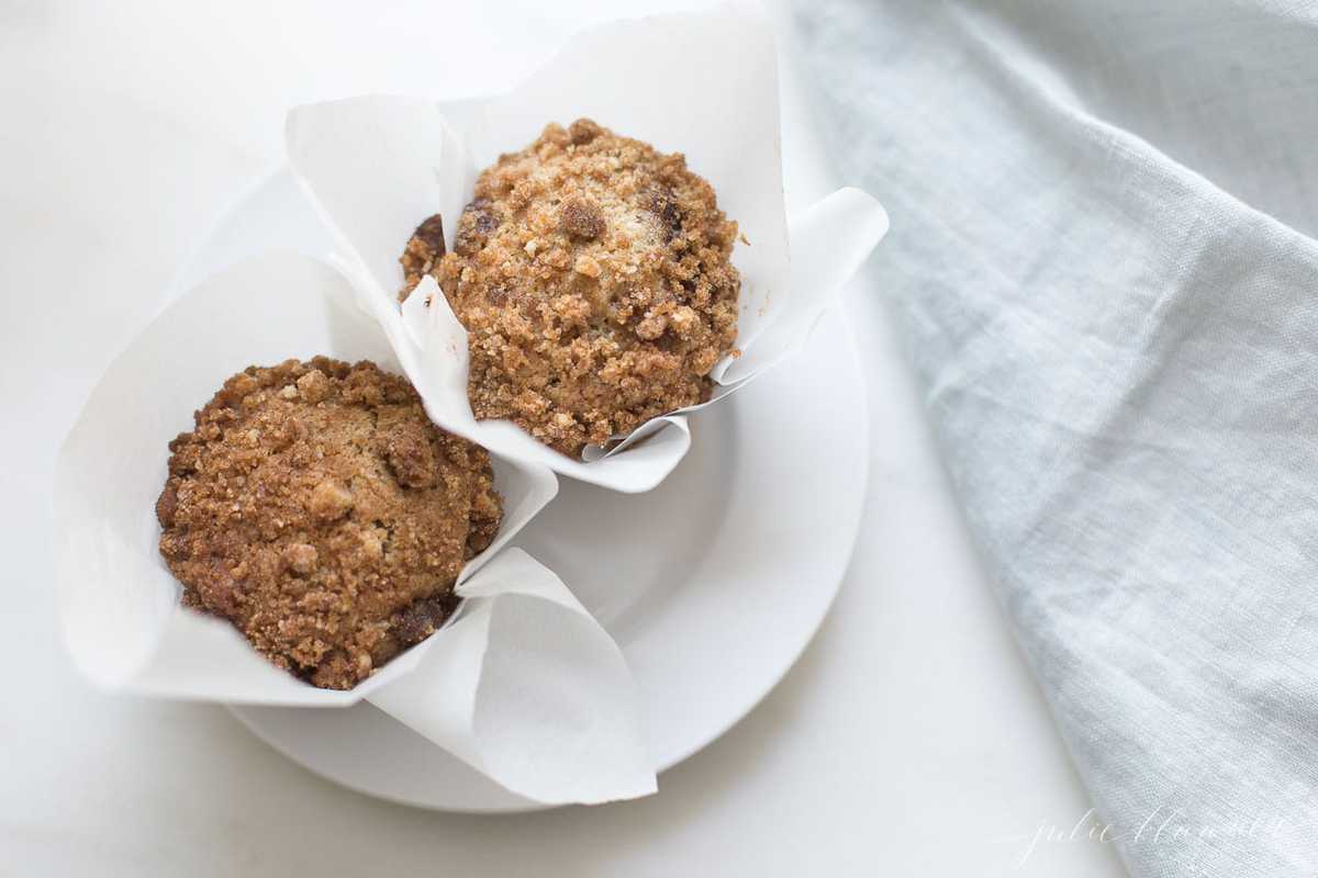 muffins with crumb topping on a white plate