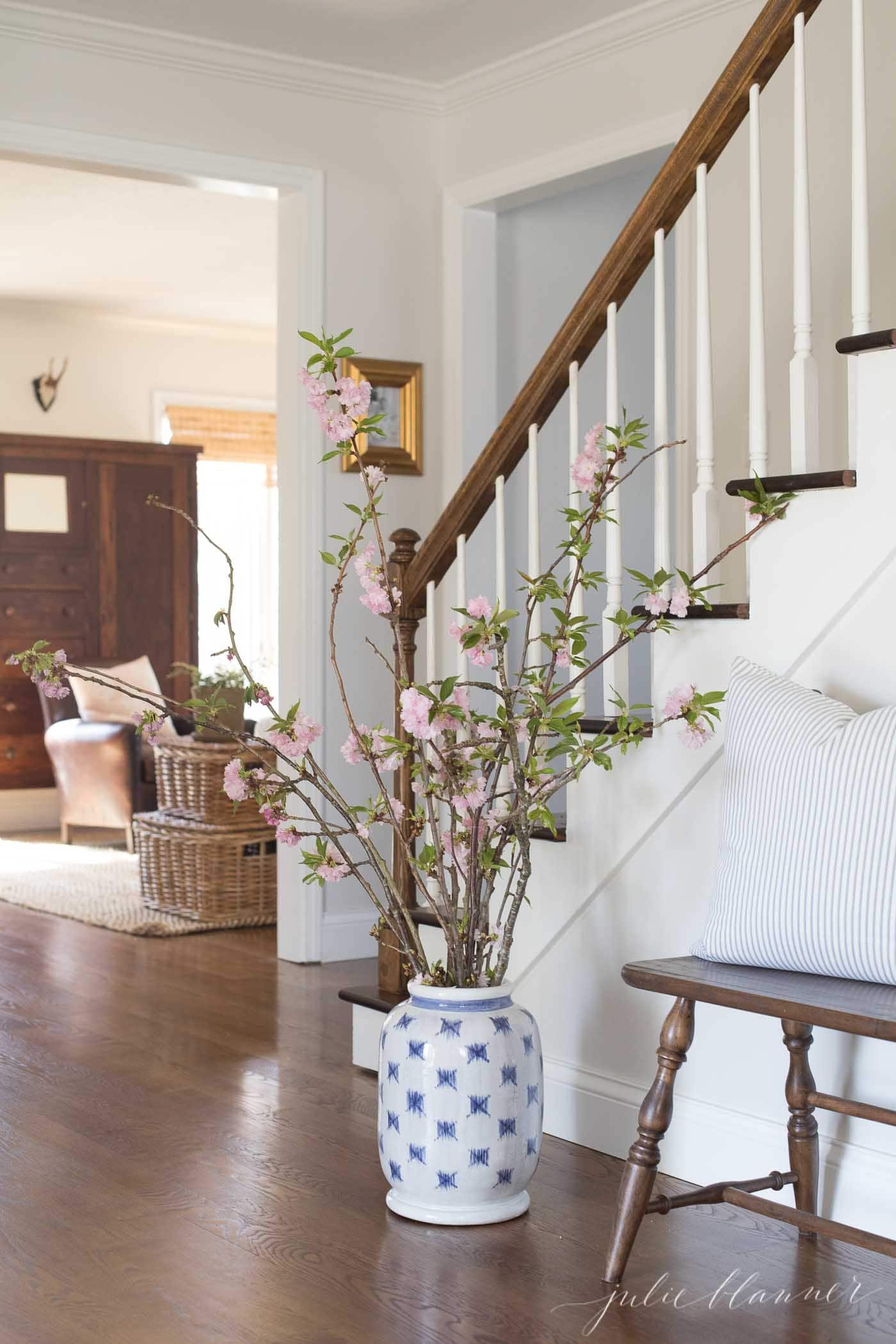 cherry blossom branches in blue and white patterned vase