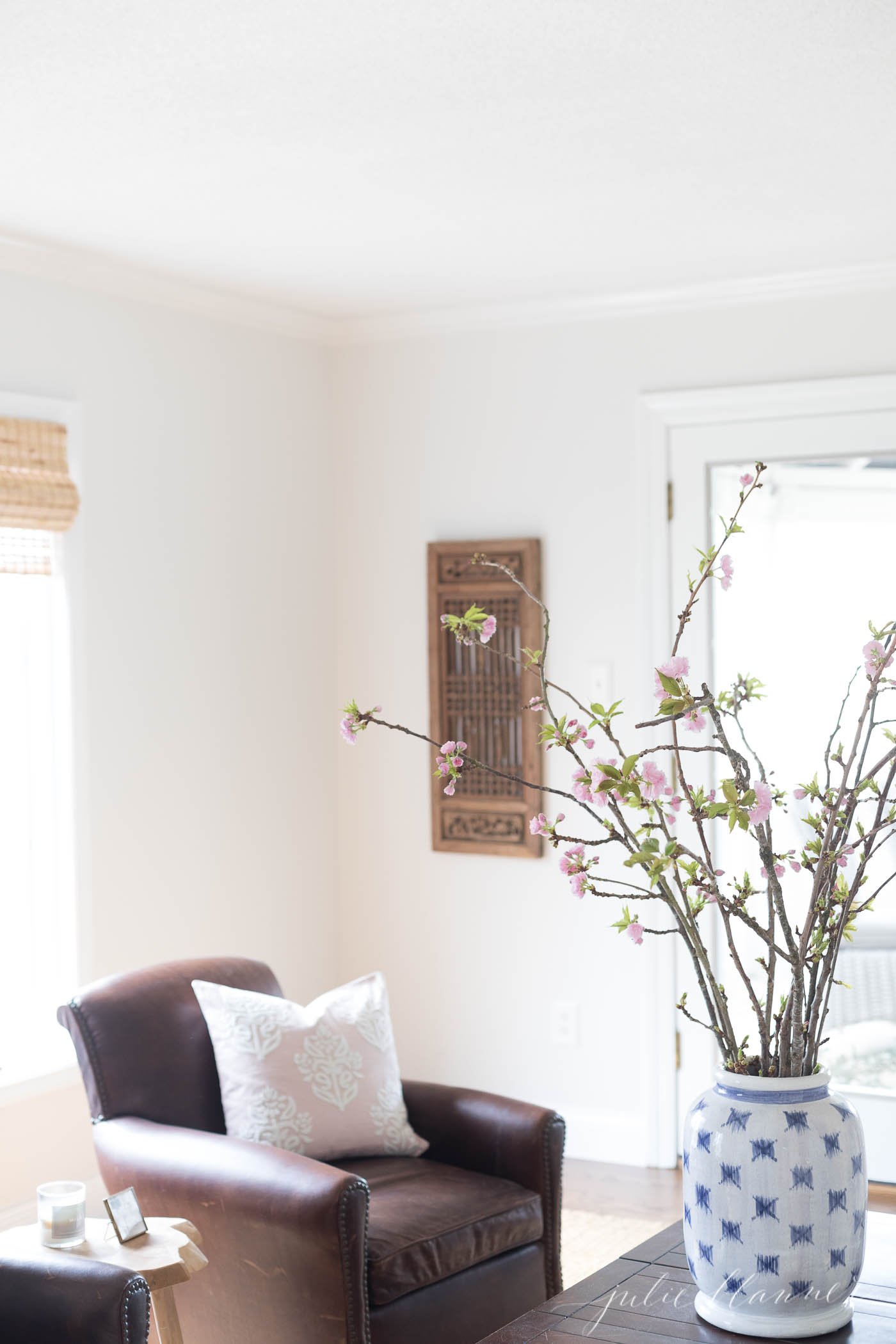 cherry blossom branches in blue and white patterned vase