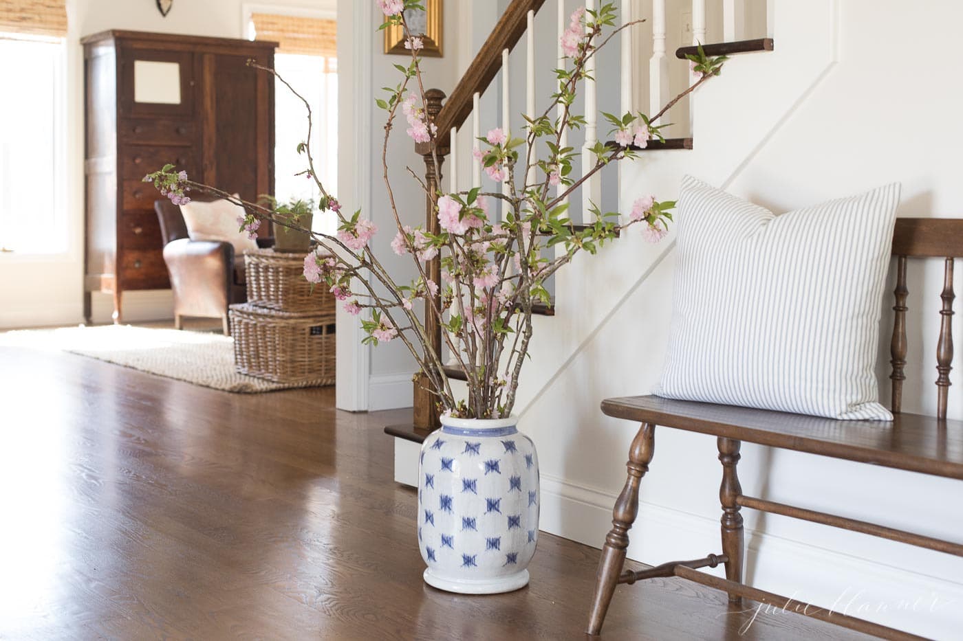 cherry blossom branches in blue and white patterned vase