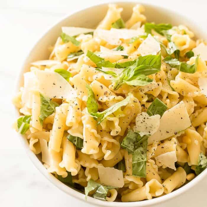 pasta salad with basil in white bowl
